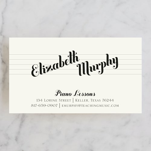 This is a black business cards by Ann Gardner called piano lessons printing on signature in standard