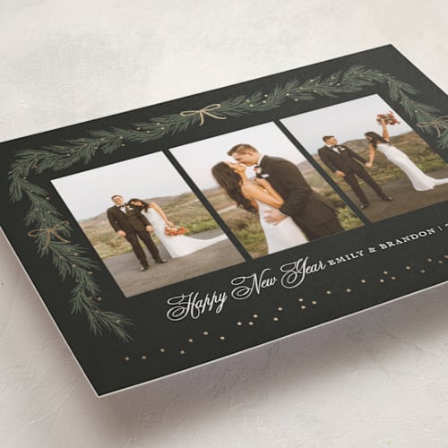 This is a midnight foil pressed holiday cards with foil pressed by Elly called ribbon garland printing on recycled smooth signature in standard