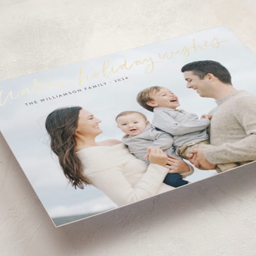 This is a sugar plum foil pressed holiday cards with foil pressed by Kristen Magee called warm holiday wishes script printing on recycled smooth signature in standard