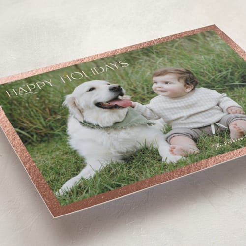 This is a cream foil pressed holiday cards with foil pressed by Hooray Creative called gilded border printing on recycled smooth signature in standard