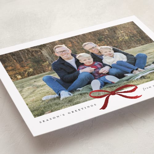 This is a coal foil pressed holiday cards with foil pressed by Olivia Kanaley Inman called crimson bow printing on recycled smooth signature in standard