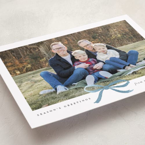 This is a mist foil pressed holiday cards with foil pressed by Olivia Kanaley Inman called crimson bow printing on recycled smooth signature in standard