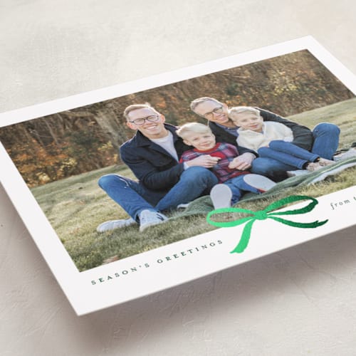 This is a evergreen foil pressed holiday cards with foil pressed by Olivia Kanaley Inman called crimson bow printing on recycled smooth signature in standard