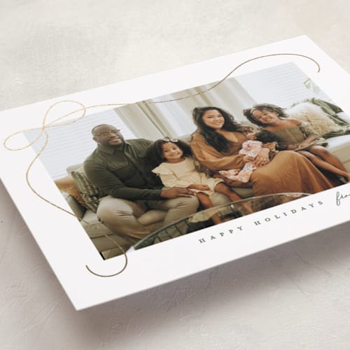 This is a snow foil pressed holiday cards with foil pressed by Lauren Chism called cascading bow printing on recycled smooth signature in standard