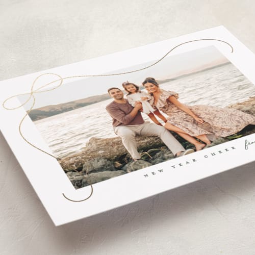 This is a snow foil pressed holiday cards with foil pressed by Lauren Chism called cascading bow printing on recycled smooth signature in standard