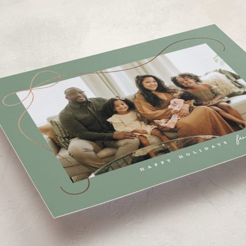 This is a sage foil pressed holiday cards with foil pressed by Lauren Chism called cascading bow printing on recycled smooth signature in standard