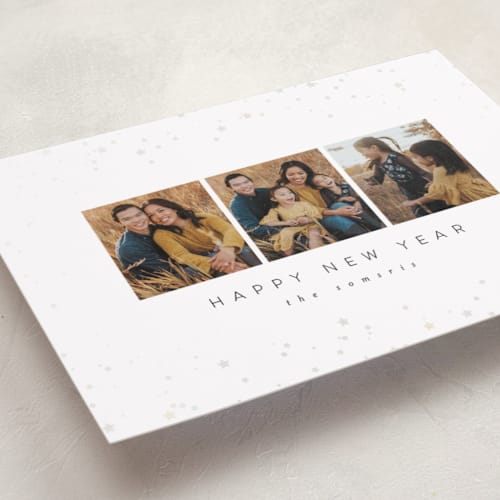 This is a snowy gloss press holiday cards with gloss press by Carolyn Nicks called confetti stars printing on recycled smooth signature in standard