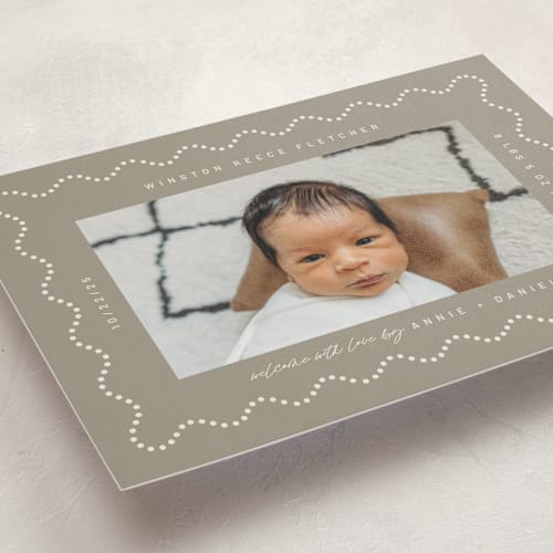 This is a sand birth announcements with standard by Kelly Watkins called squiggle printing on signature in standard
