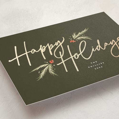 This is a pine foil pressed holiday cards with foil pressed by Robert and Stella called holiday script printing on signature in standard