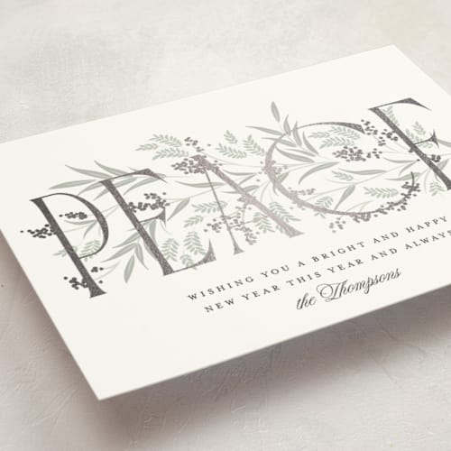 This is a snow foil pressed holiday cards with foil pressed by Robert and Stella called entwined peace printing on signature in standard