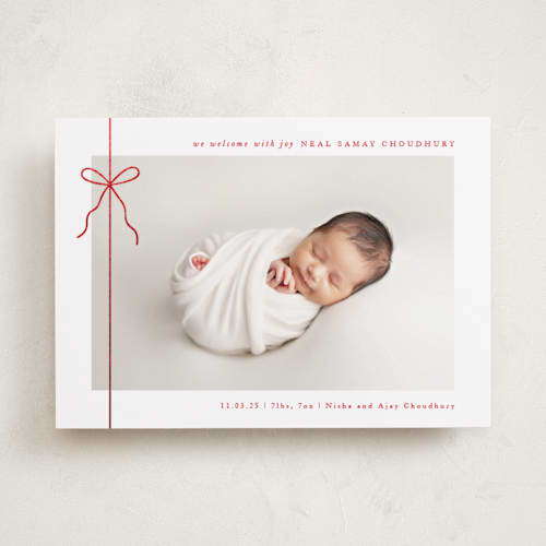 This is a crisp bow babys first christmas with foil pressed by Olivia Raufman called crisp bow printing on recycled smooth signature in standard