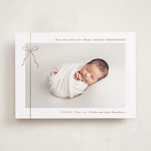 This is a cranberry babys first christmas with foil pressed by Olivia Raufman called crisp bow printing on recycled smooth signature in standard