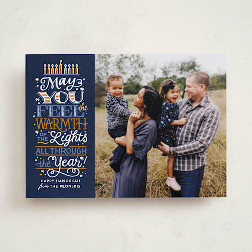 This is a navy hanukkah cards with standard by Laura Bolter called candle warmth printing on recycled smooth signature in standard