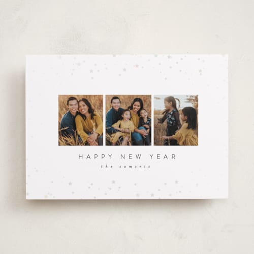 This is a snowy gloss press holiday cards with gloss press by Carolyn Nicks called confetti stars printing on recycled smooth signature in standard