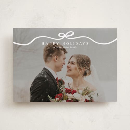 This is a snow holiday photo cards with standard by Kaydi Bishop called bow tied printing on recycled smooth signature in standard