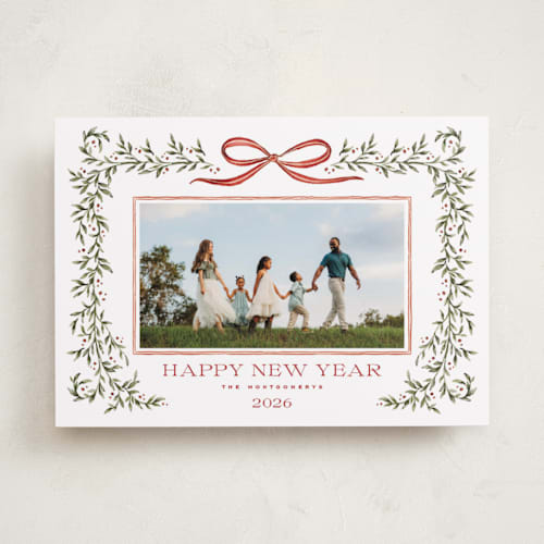 This is a holly berry holiday photo cards with standard by Wildfield Paper Co called laurel wreath printing on recycled smooth signature in standard