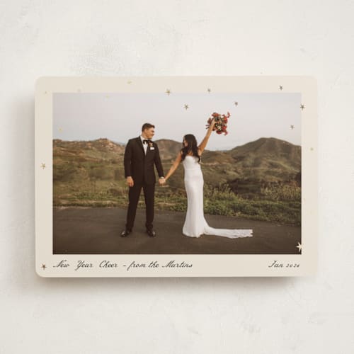 This is a cream foil pressed holiday cards with foil pressed by Ani Somi called star dust printing on recycled smooth signature in standard