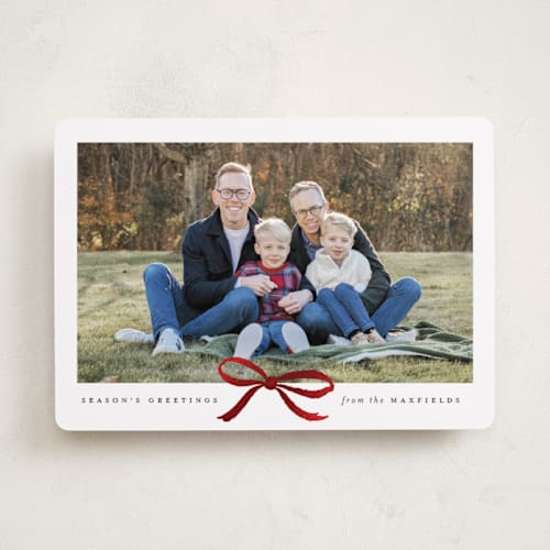 This is a coal foil pressed holiday cards with foil pressed by Olivia Kanaley Inman called crimson bow printing on recycled smooth signature in standard