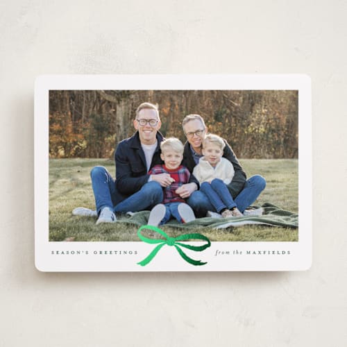 This is a evergreen foil pressed holiday cards with foil pressed by Olivia Kanaley Inman called crimson bow printing on recycled smooth signature in standard
