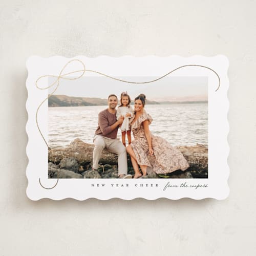 This is a snow foil pressed holiday cards with foil pressed by Lauren Chism called cascading bow printing on recycled smooth signature in standard