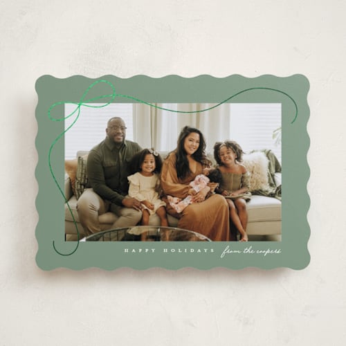 This is a sage foil pressed holiday cards with foil pressed by Lauren Chism called cascading bow printing on recycled smooth signature in standard