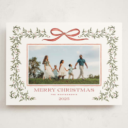 This is a holly berry holiday photo cards with standard by Wildfield Paper Co called laurel wreath printing on signature in grand