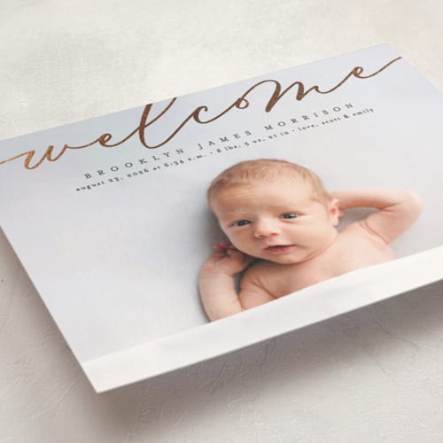 This is a charcoal birth announcement postcards with foil pressed by Erica Krystek called welcome ribbon printing on signature in postcard