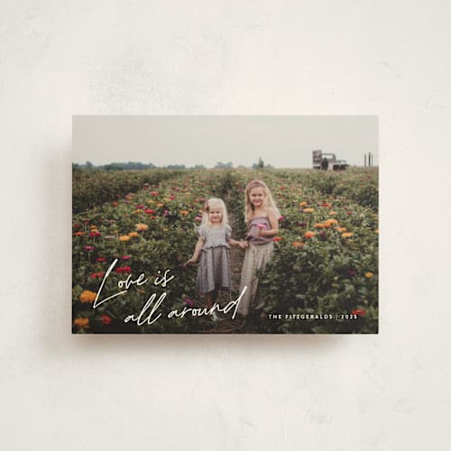 This is a cloud valentine postcards with standard by Jackie Crawford called love is all around script printing on signature in postcard