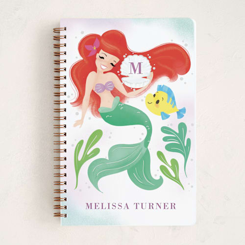 This is a lilac journals with standard by Sabrin Deirani called disney's little mermaid shellebrate! printing on premium cover stock in notebook