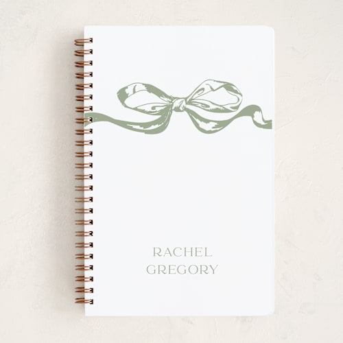 This is a olive journals with standard by Teju Reval called big bow printing on premium cover stock in notebook