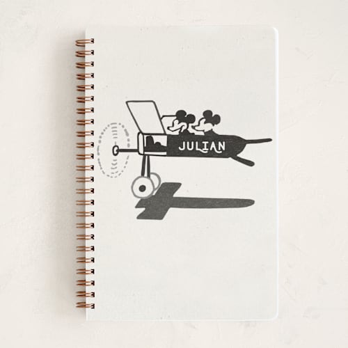 This is a ivory journals with standard by Sumak Studio called disney's mickey and minnie on the plane printing on premium cover stock in notebook