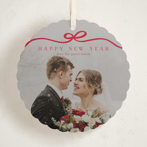 This is a cardinal holiday card ornaments with standard by Kaydi Bishop called bow tied printing on recycled smooth signature in ornament