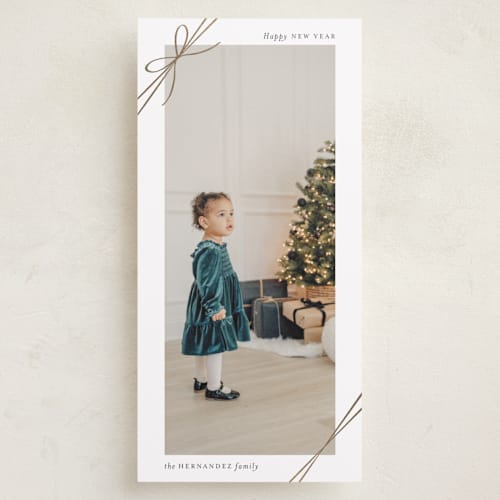 This is a snow foil pressed holiday cards with foil pressed by Heather Schertzer called tied with ribbon printing on recycled smooth signature in tall