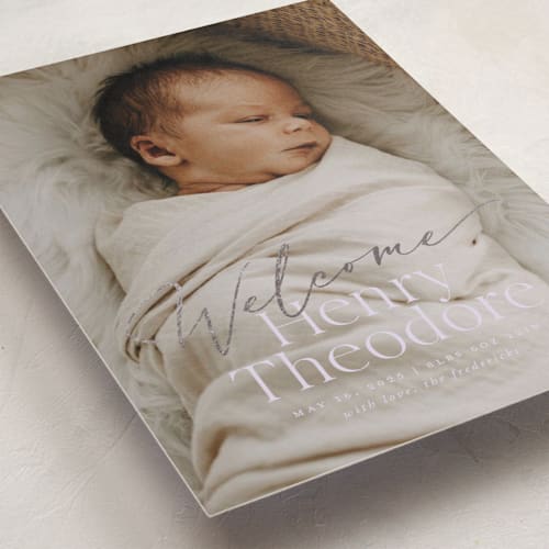 This is a lilac foil stamped birth announcements with foil pressed by Jackie Crawford called scripted welcome printing on smooth signature in standard