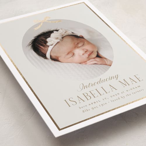 This is a cashmere foil stamped birth announcements with foil pressed by Erin German called tied with a bow printing on smooth signature in standard