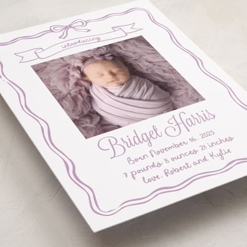 This is a lavander birth announcements with standard by Cass Loh called bow frame printing on smooth signature in standard