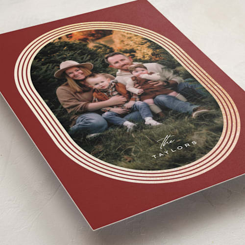 This is a cranberry foil pressed holiday cards with foil pressed by Brittany Braithwaite called gilded ovals printing on recycled smooth signature in standard