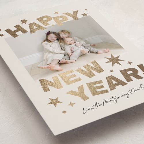 This is a champagne foil pressed holiday cards with foil pressed by Kercia Jane called big year energy printing on recycled smooth signature in standard