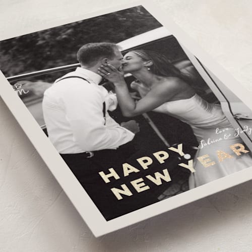 This is a ivory foil pressed holiday cards with foil pressed by Benita Crandall called glittering love printing on recycled smooth signature in standard