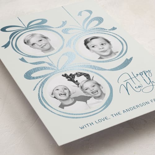This is a snowball foil pressed holiday cards with foil pressed by Paper Sun Studio called baubles and bows printing on recycled smooth signature in standard