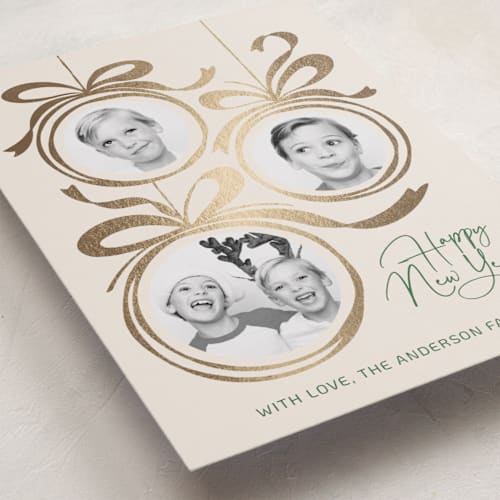 This is a champagne foil pressed holiday cards with foil pressed by Paper Sun Studio called baubles and bows printing on recycled smooth signature in standard