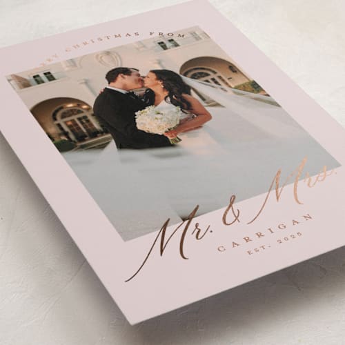 This is a dusty rose foil pressed holiday cards with foil pressed by Pink House Press called mr. and mrs. printing on recycled smooth signature in standard