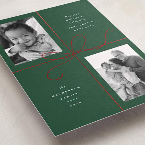 This is a holly foil pressed holiday cards with foil pressed by Emily Betts called bow two printing on recycled smooth signature in standard