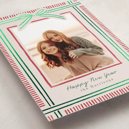 This is a ruby foil pressed holiday cards with foil pressed by Chris Griffith called holiday wrap printing on recycled smooth signature in standard