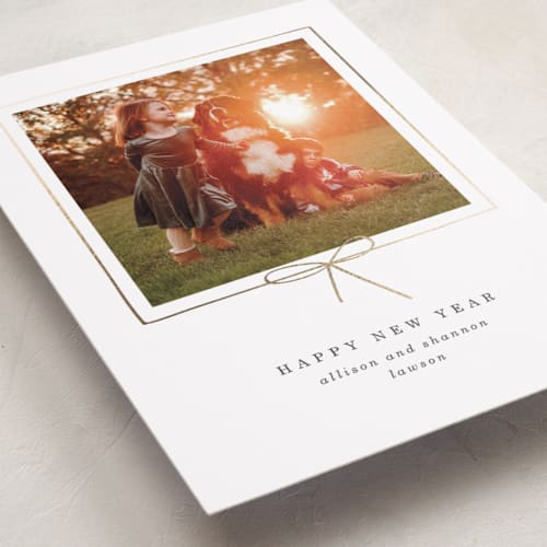 This is a dusk foil pressed holiday cards with foil pressed by Baumbirdy called little bow printing on recycled smooth signature in standard