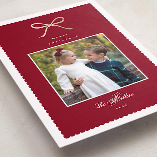 This is a cranberry foil pressed holiday cards with foil pressed by Emily Betts called scallop bow printing on recycled smooth signature in standard