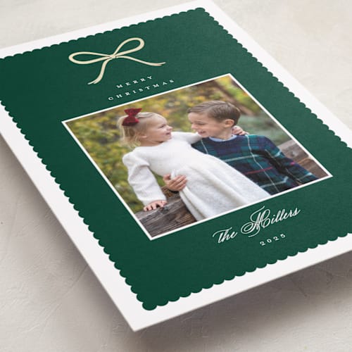 This is a pine foil pressed holiday cards with foil pressed by Emily Betts called scallop bow printing on recycled smooth signature in standard