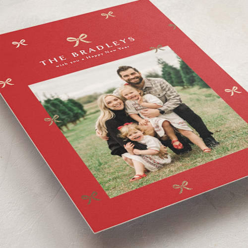 This is a cardinal foil pressed holiday cards with foil pressed by Melanie Kosuge called bow-tied printing on recycled smooth signature in standard