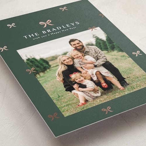 This is a evergreen foil pressed holiday cards with foil pressed by Melanie Kosuge called bow-tied printing on recycled smooth signature in standard