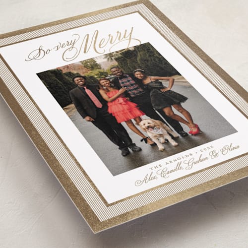 This is a caramel foil pressed holiday cards with foil pressed by Alston Foster called merry striped frame printing on recycled smooth signature in standard
